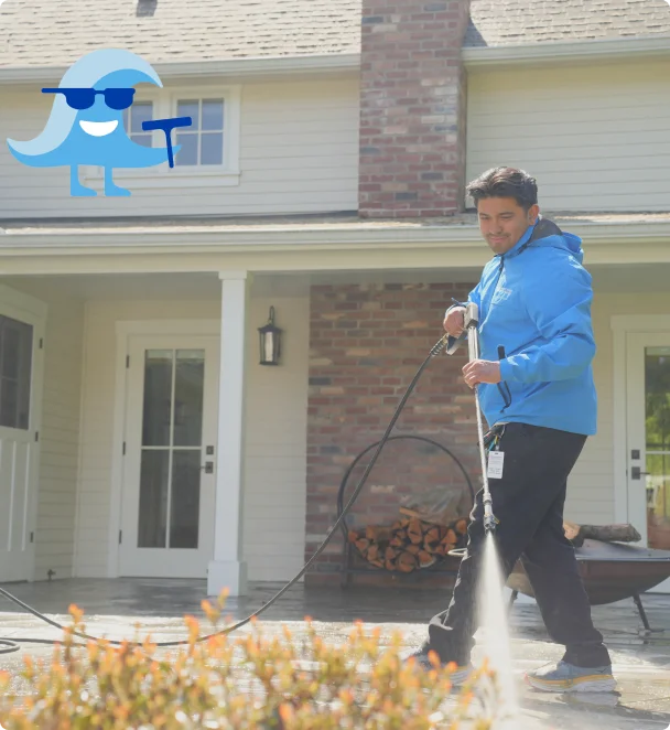 Johnny Tsunami technician performing commercial exterior cleaning at a business property in Kitsap County