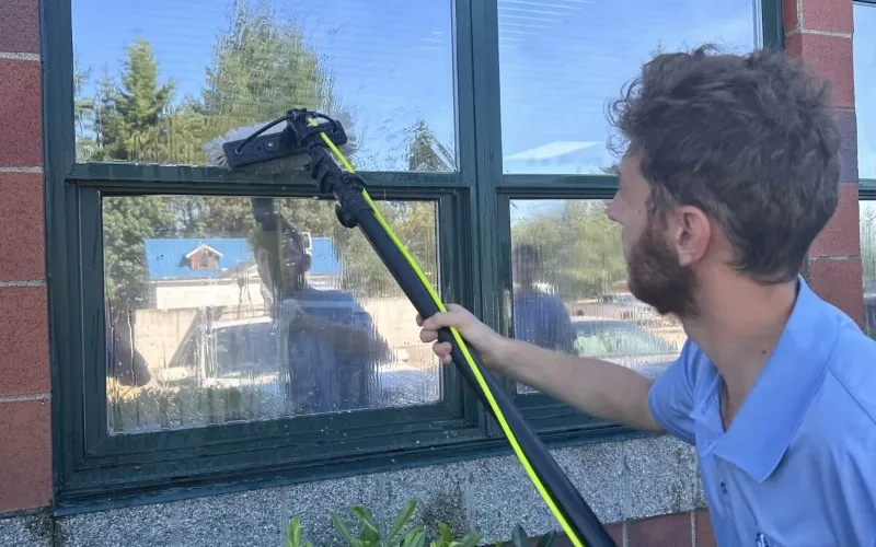 Commercial window cleaning technician cleaning exterior glass for a business property in Seattle