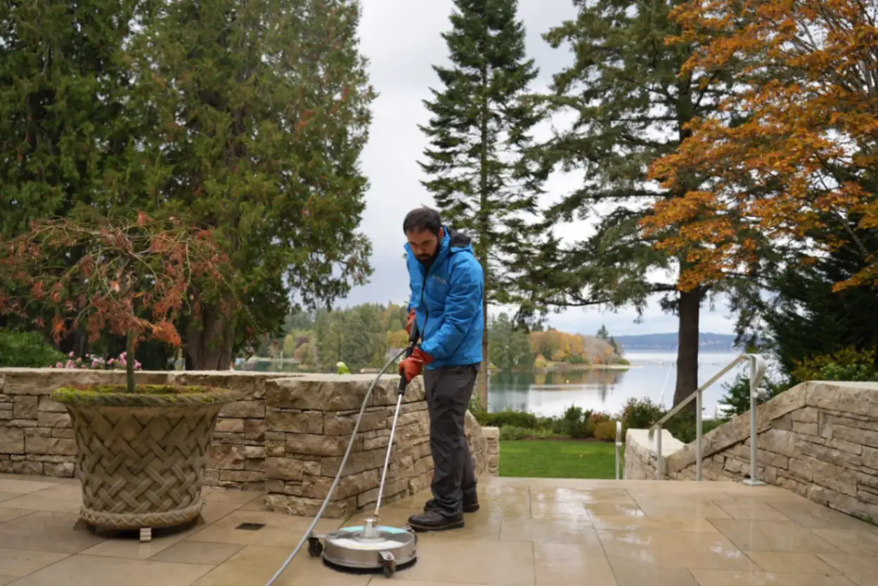 Roof moss removal specialist applying safe moss treatment to residential roof in Bremerton WA