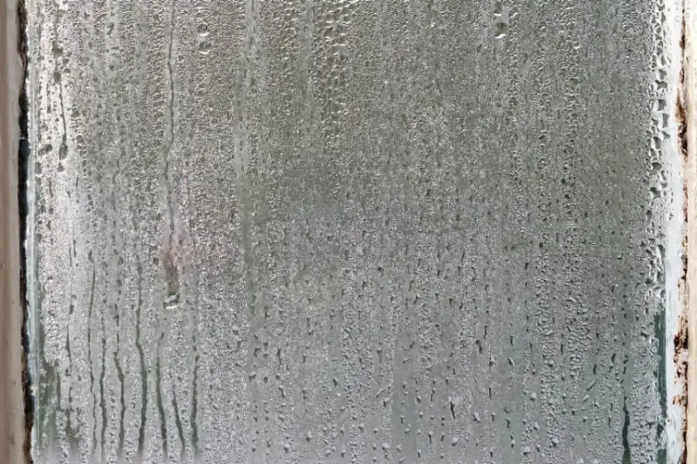 Dirty window glass with visible buildup before professional cleaning