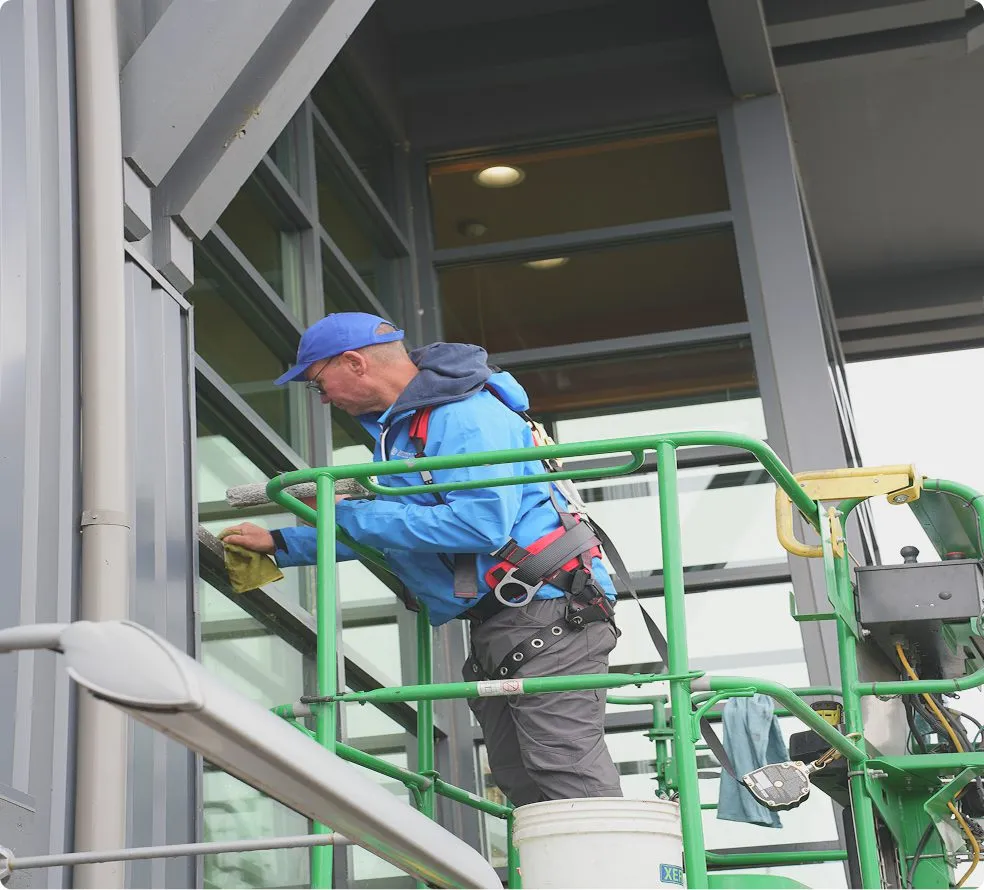 Window cleaning process showing professional inspection and cleaning preparation