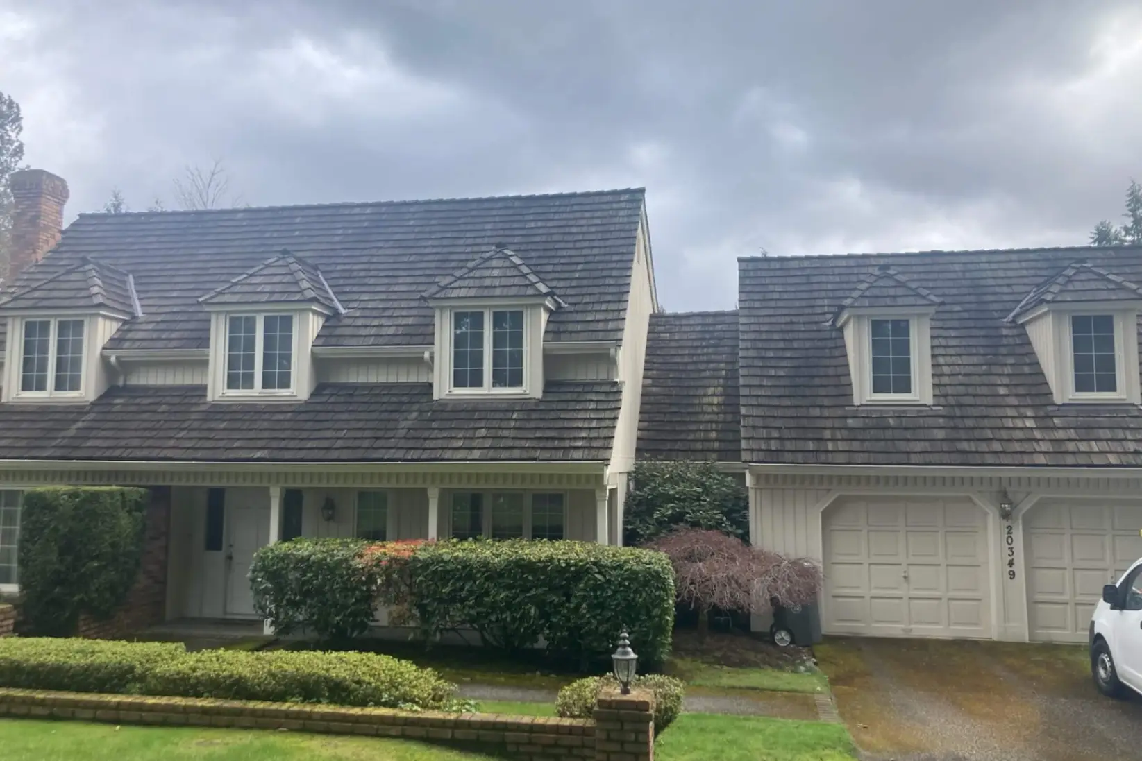 Before soft washing showing stained home exterior with dirt and mildew in Bremerton
