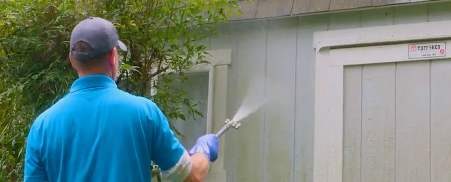 Soft washing exterior siding using low-pressure cleaning