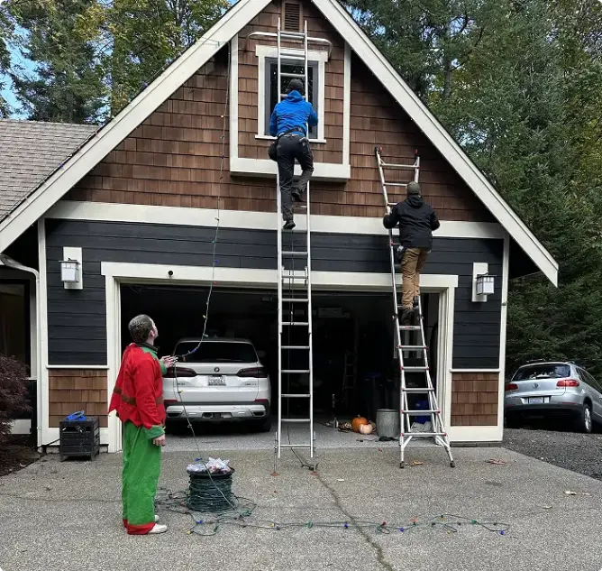 Technician preparing residential holiday light installation equipment