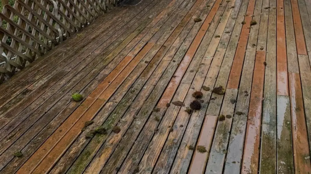 Wooden deck with dirt and surface buildup before pressure washing